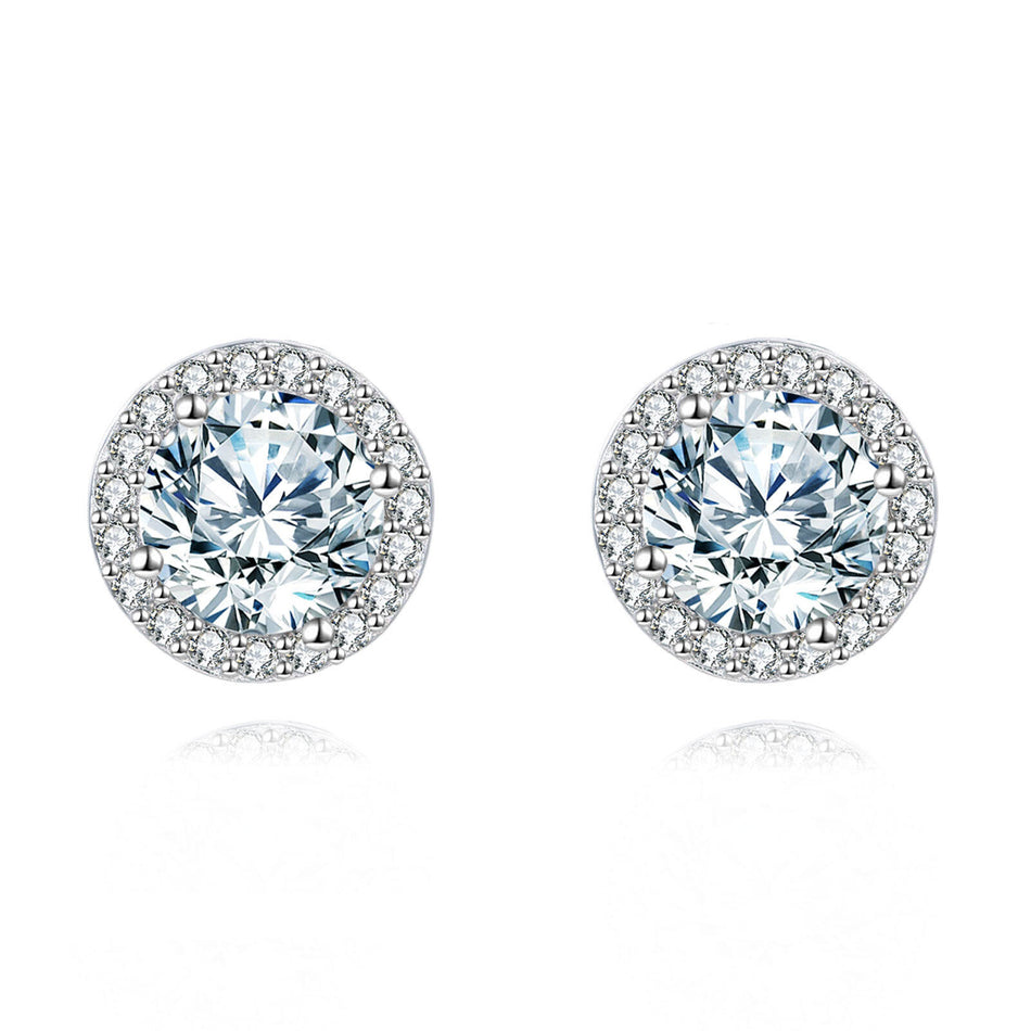 925 Sterling Silver Elegant Moissanite Halo Stud Earrings On Black Wood With Teal Background